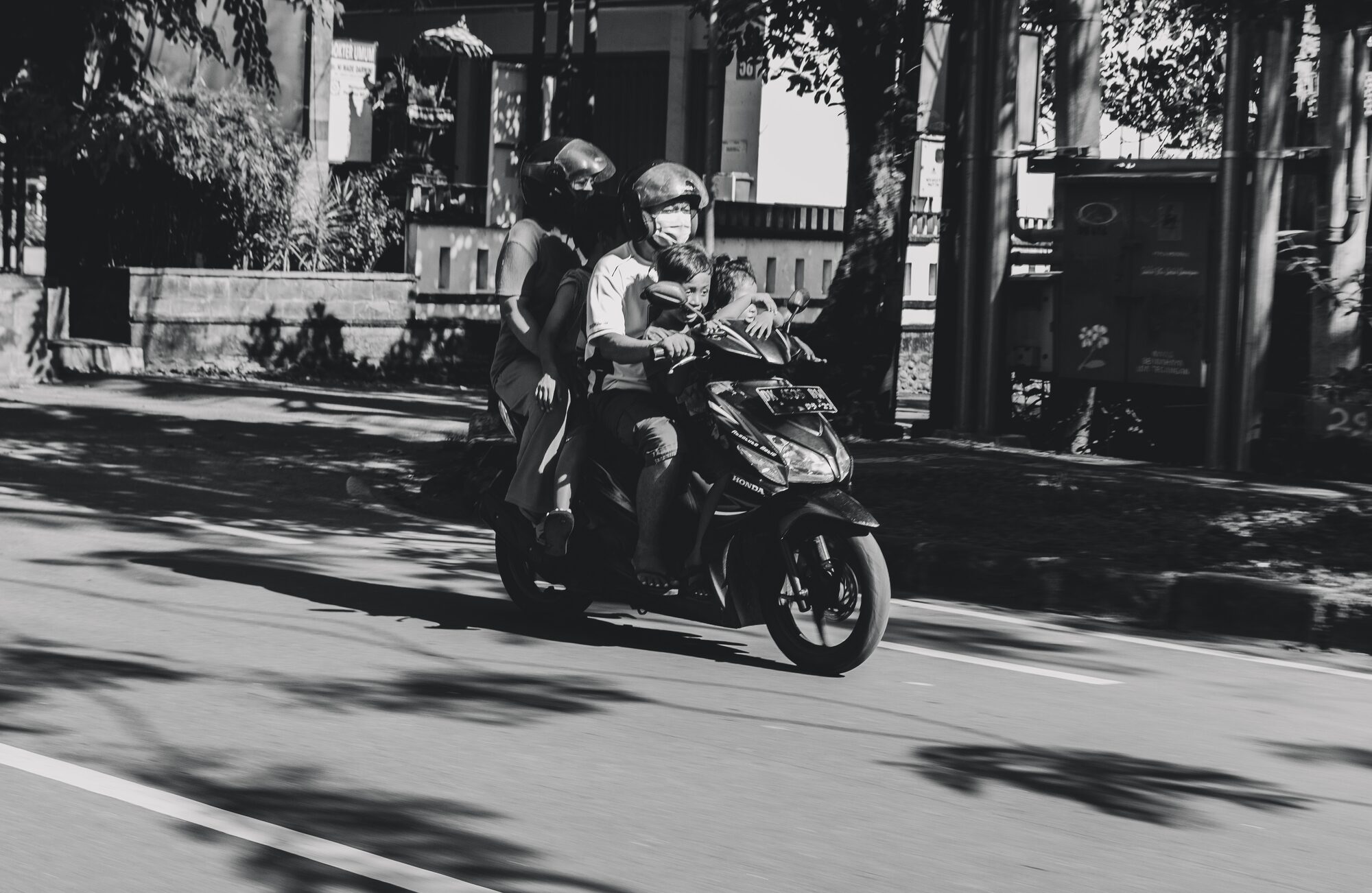 A family riding together on a scooter in Bali